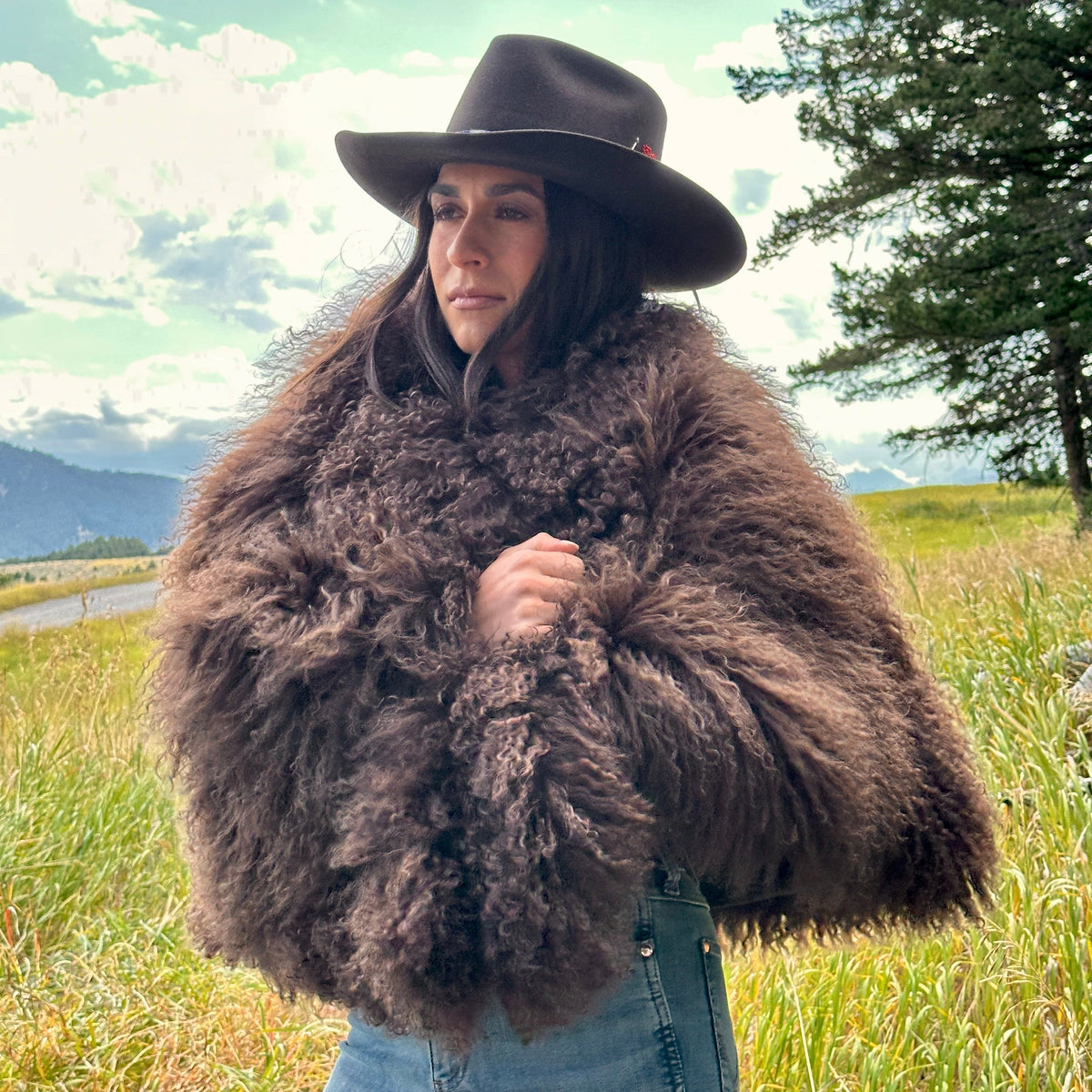 woman wearing Mongolian goat cape in rich brown, designed by Jenny Keller of Bridger Leather