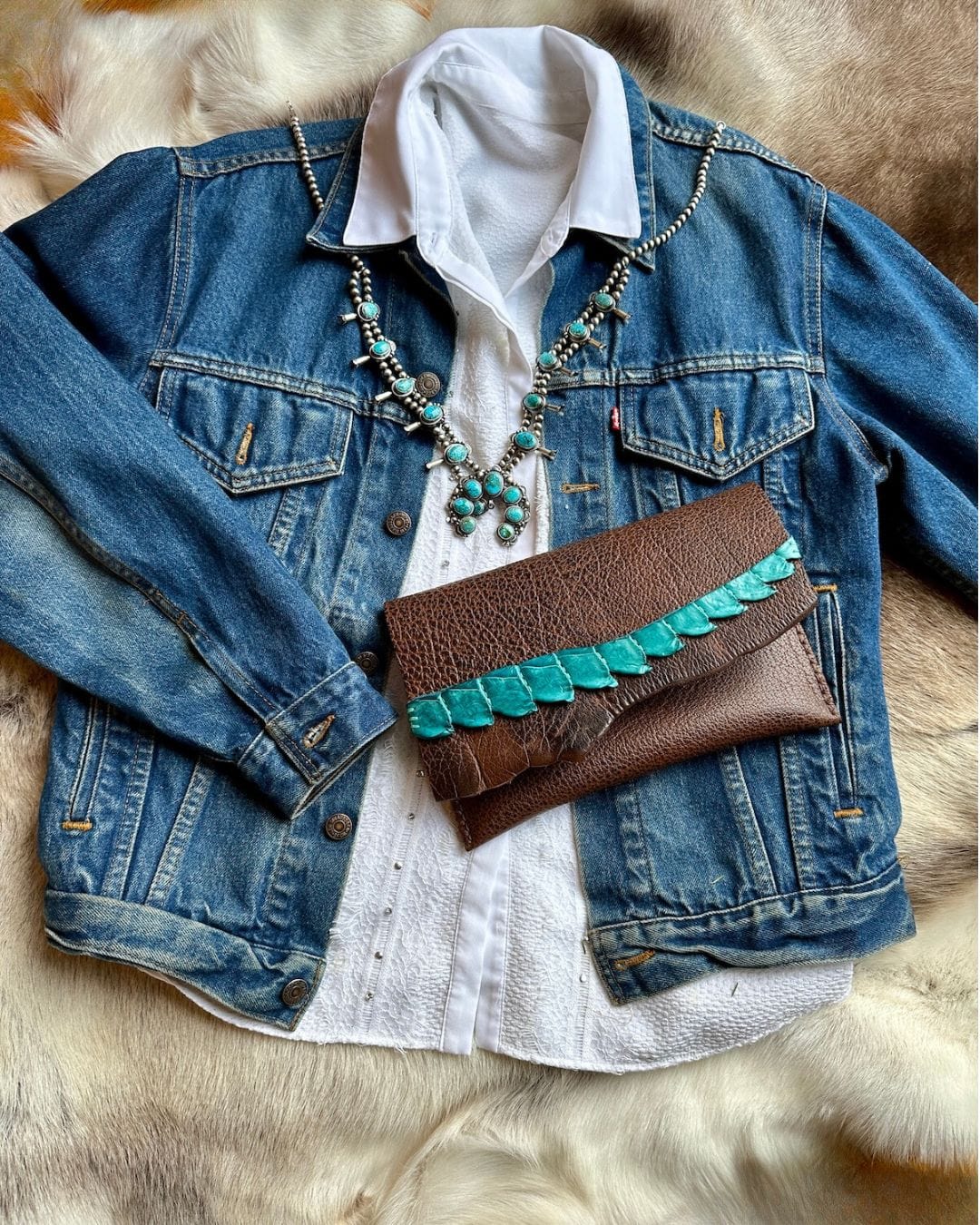 Water Buffalo Leather Clutch with Crocodile Trim  paired with a denim jacket and squash blossom necklace for the complete look | Bridger Leather Clutch