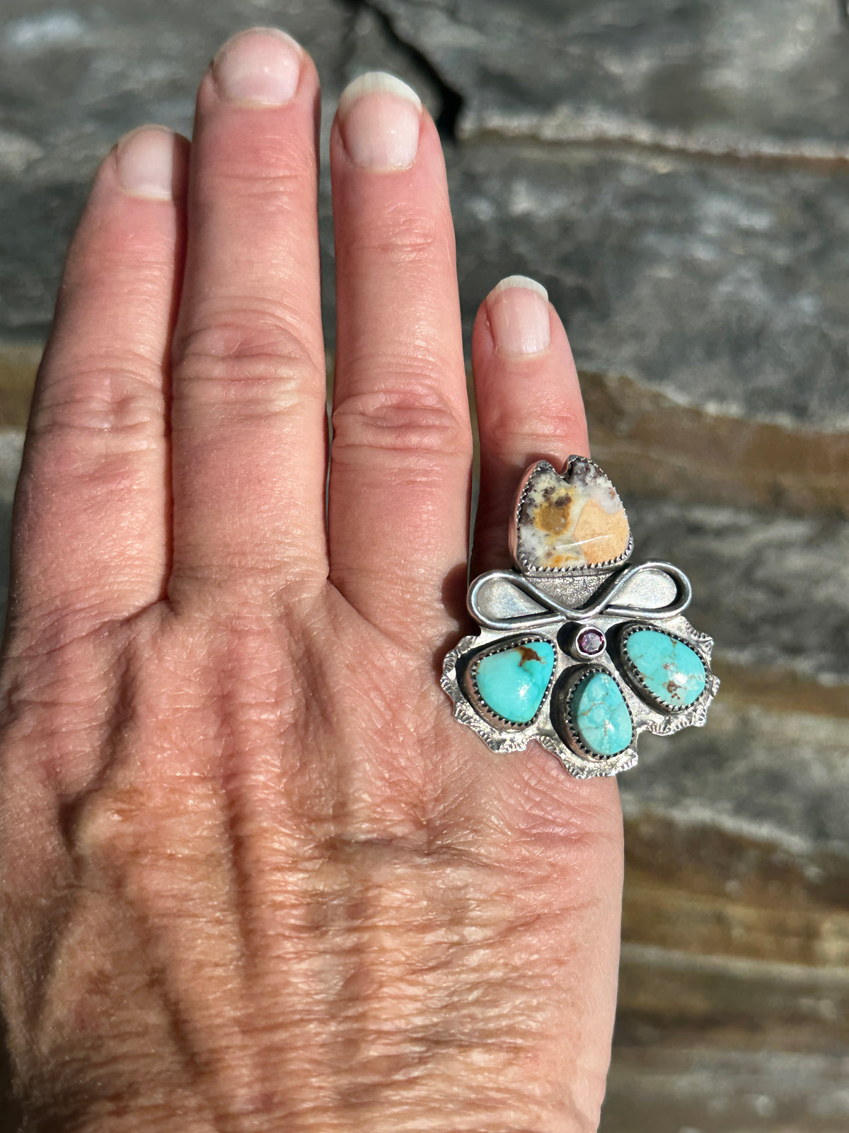 Jasper and ruby cowgirl hat ring worn on the finger, showing its size on the hand