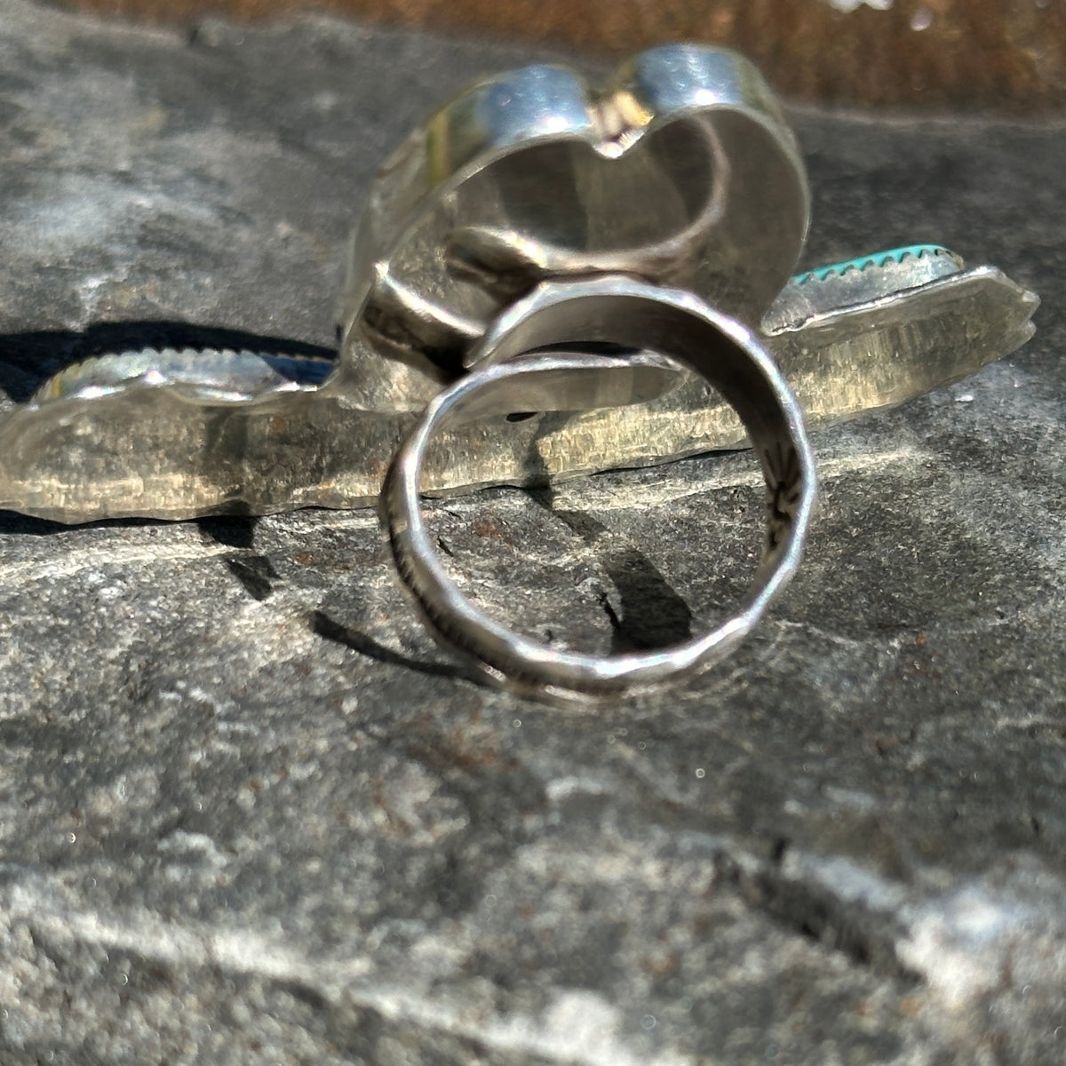 Side view of the spiderweb turquoise cowgirl hat ring showing the open, adjustable sterling silver ring band