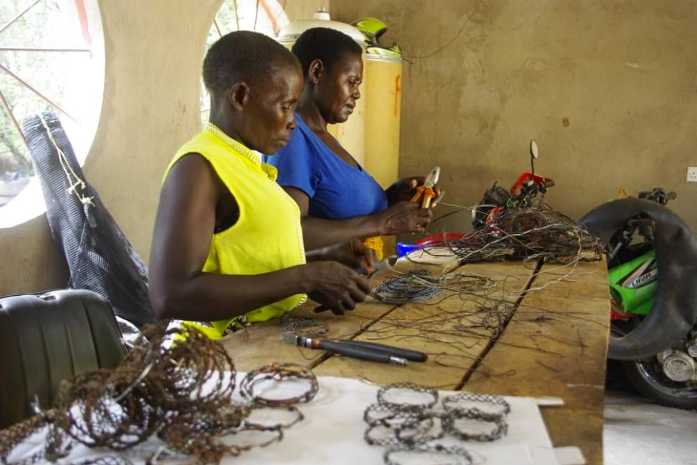 Women making bracelets and accessories from snare wire apprehended in the Luano GMA in Zambia by game scouts.