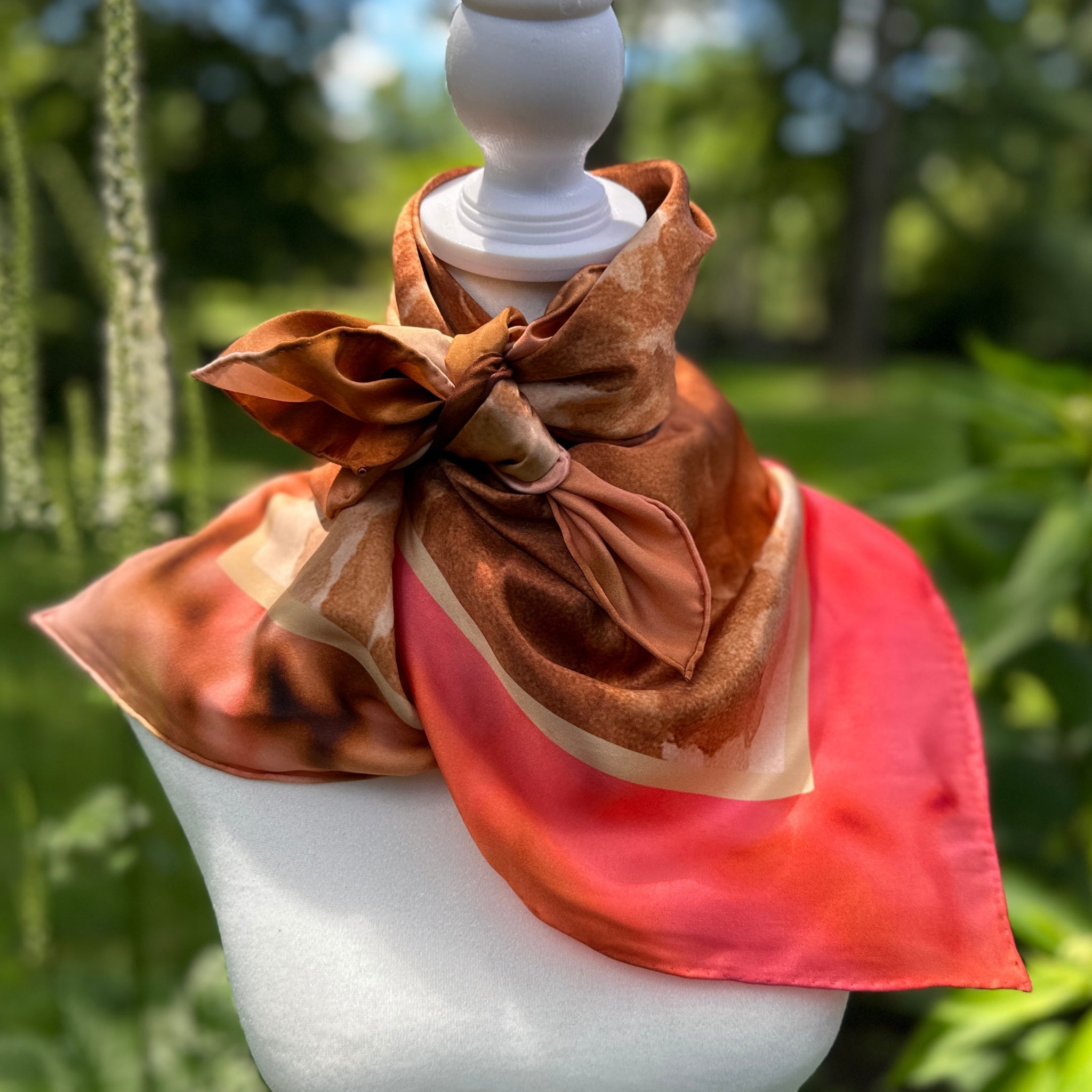 Absaroka Silk Scarf  with rose, russet oranges, and taupe palate scarf on mannequin - Bridger Leather