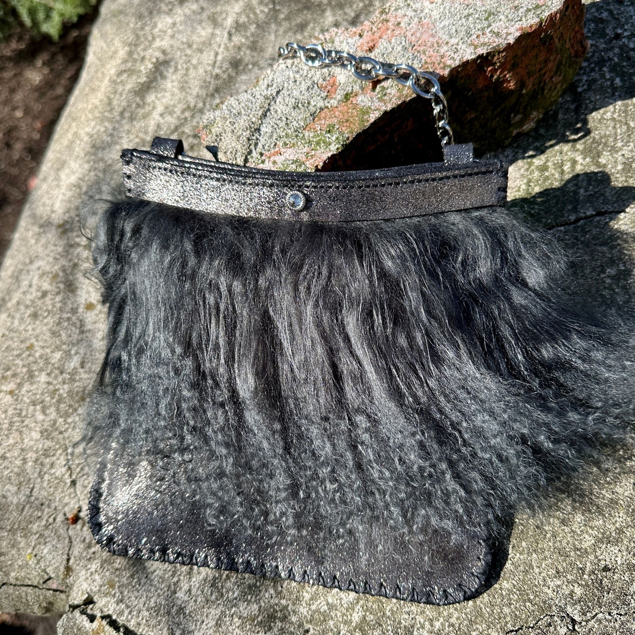 Close-up of black Mongolian lamb fur trim on Italian suede evening bag by Bridger Leather
