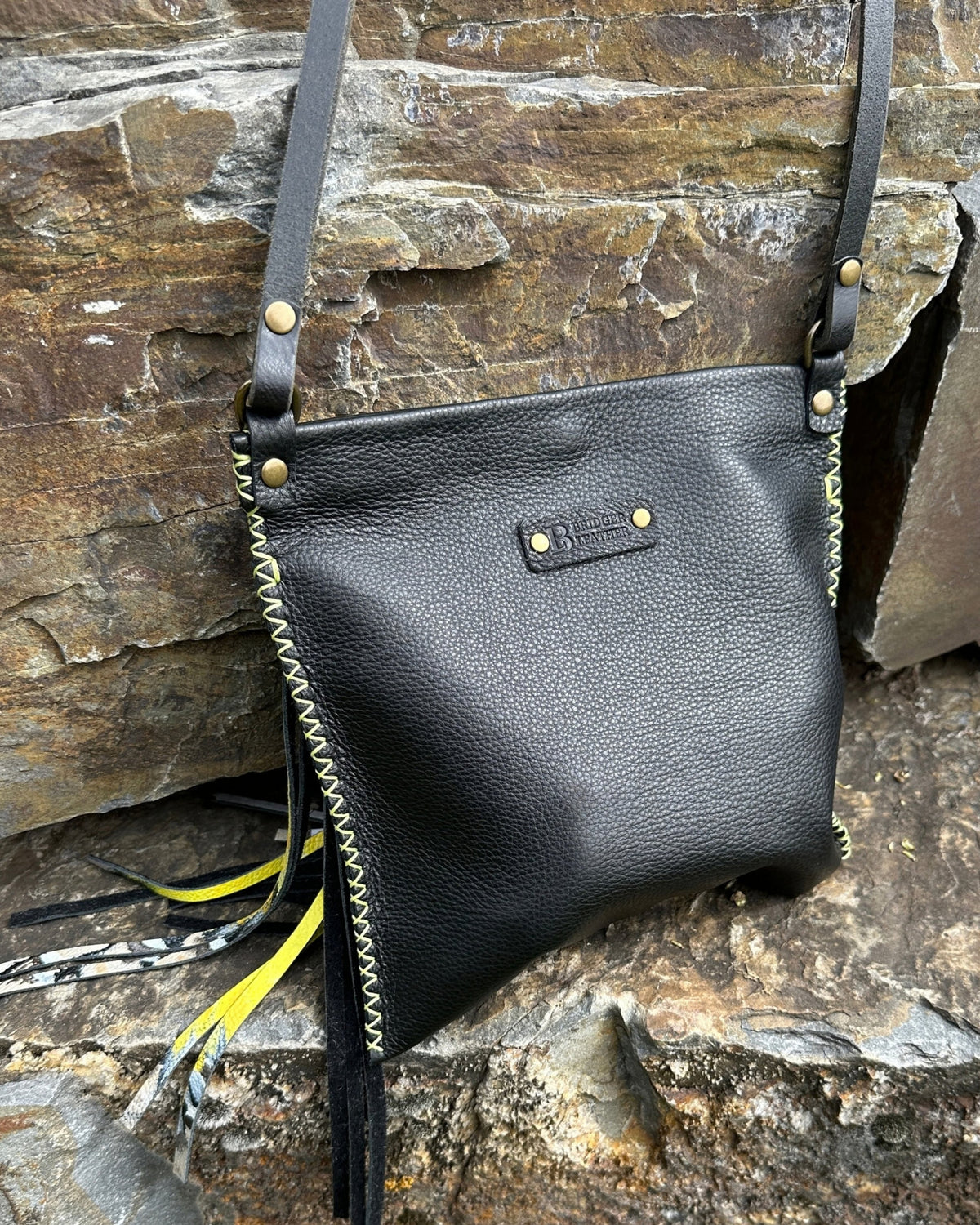 Back of the MeadowLark Crossbody with its adjustable black leather crossbody strap and maker's tab