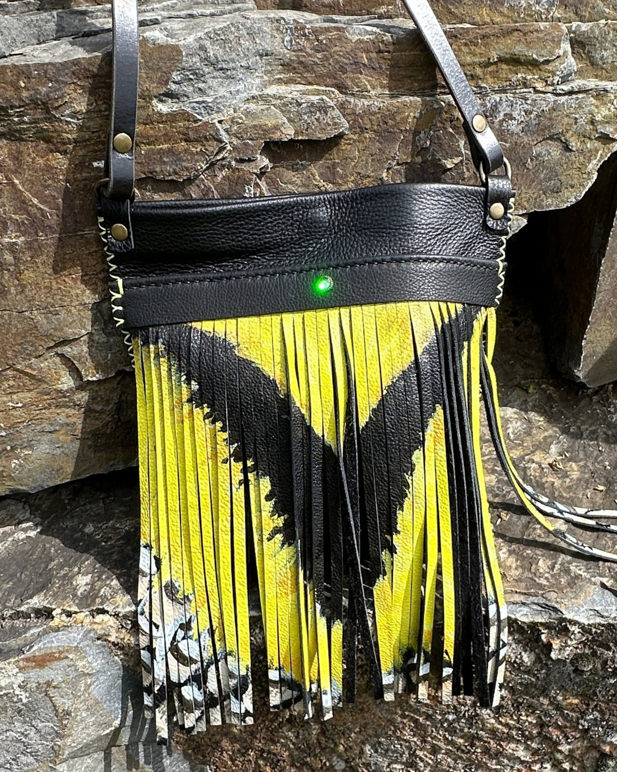 Front of the MeadowLark Crossbody showing the hand-painted yellow and black fringe and the Swarovski crystal on the front pocket