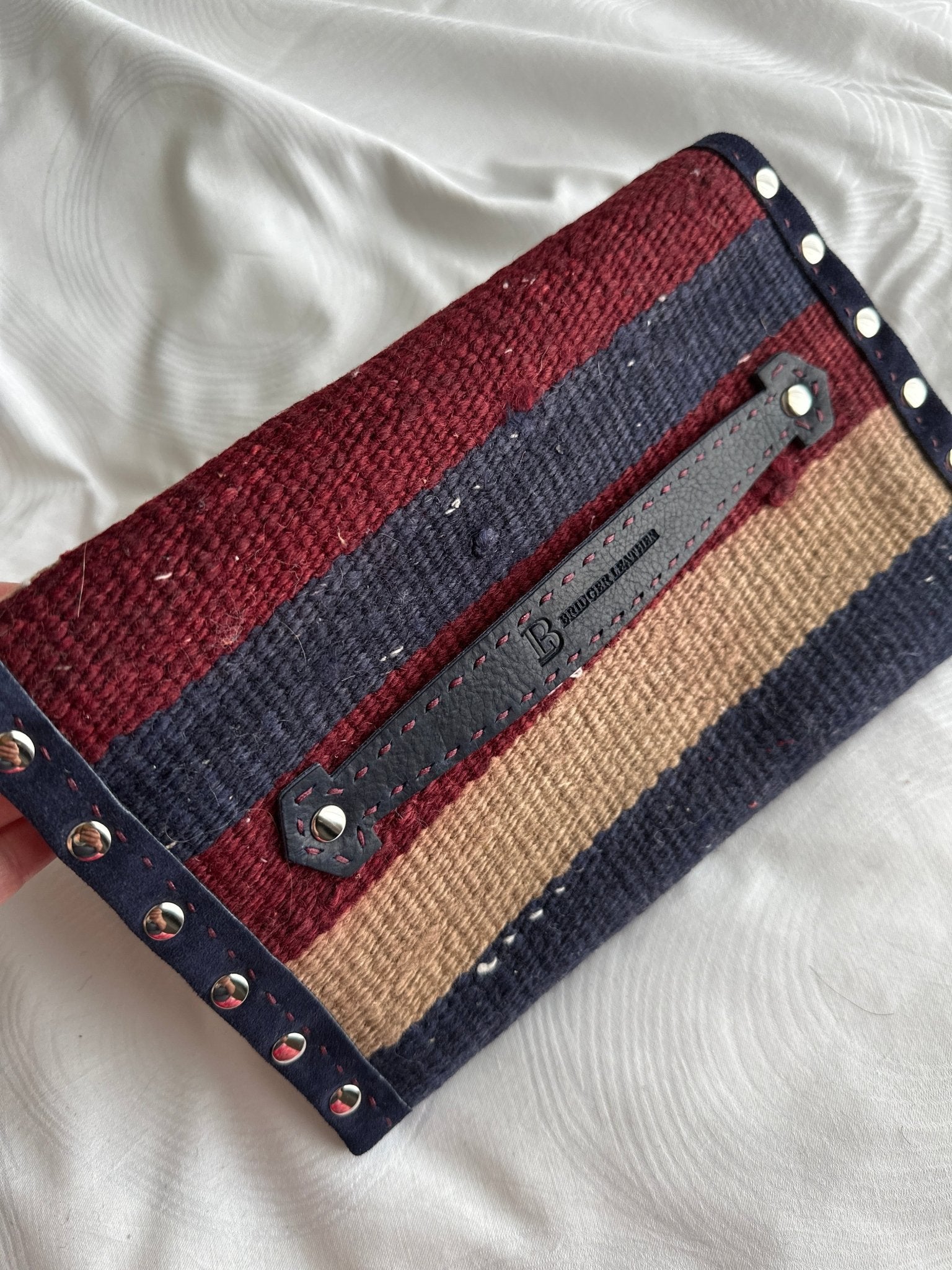 Back of woven wool clutch bag in Navy, burgundy and beige with leather trim