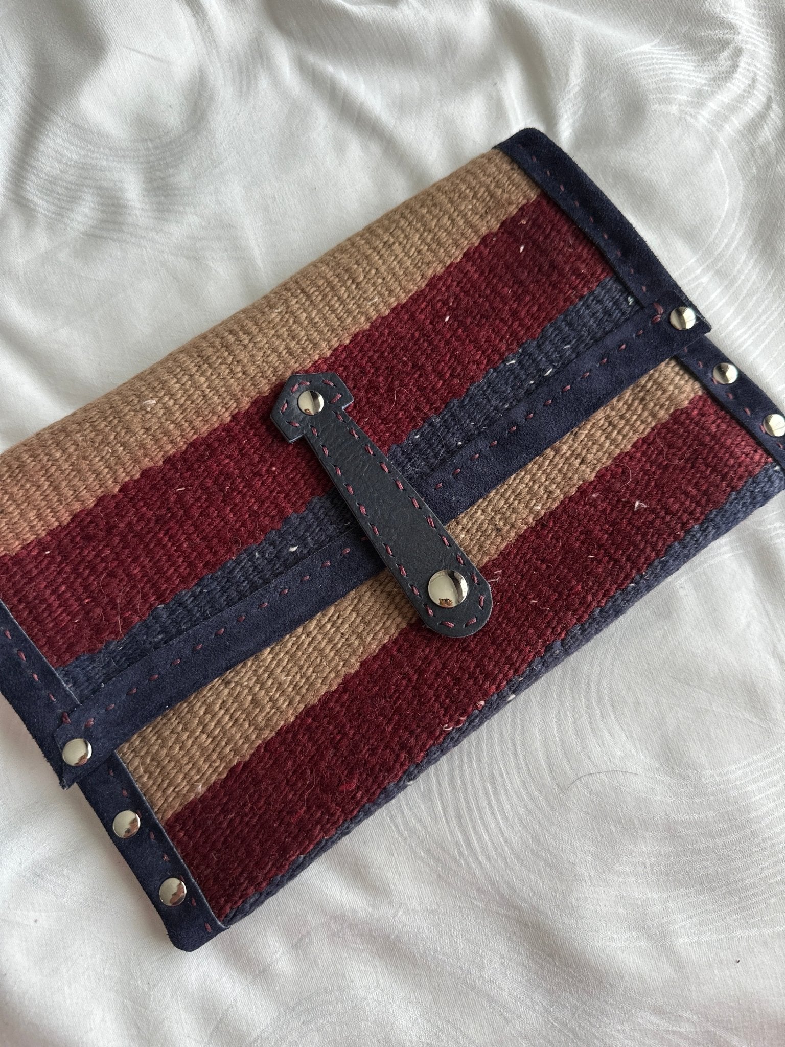 Woven wool clutch bag in Navy, burgundy and beige with leather trim.