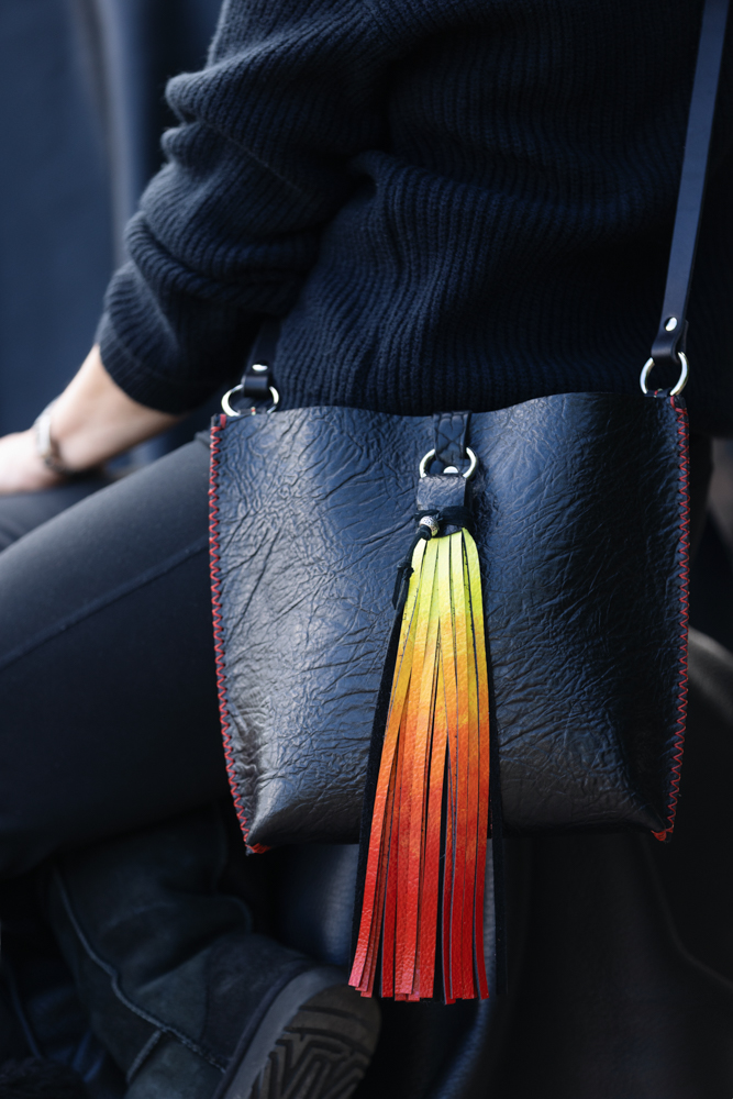 black bison crossbody bag with hand painted tassel in ombre colors of red, orange and yellow