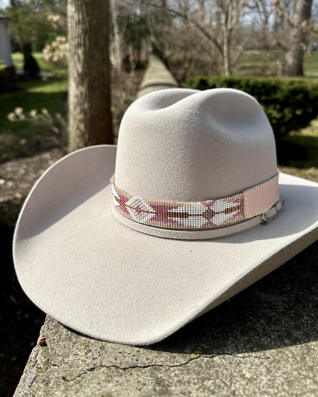 Pink and White beaded hatband on cowboy hat.